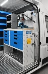 04_The plywood work bench and metal vice in the heavy equipment mechanic’s Ducato
