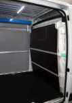 A bar and strap lashing system in a van used to service and deliver industrial cleaning machines