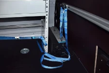 A close-up of a cargo lashing system in a carwash service van