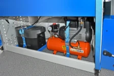A floor-level compartment in the Transporter containing an EcoFlow unit and a compressor