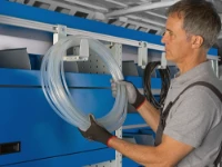A hose hung on the adjustable hooks of the Syncroblock bar