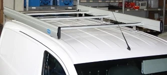 A roof rack with side fences and a loading roller on a Nissan NV200
