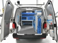 A VW Transporter with Syncro racking on the right side and bulkhead