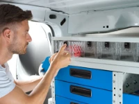 An operator using the drawer units with transparent drawers in the van