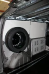 Fitted cargo area with spare wheel on the wall and Syncroblock rails at the top