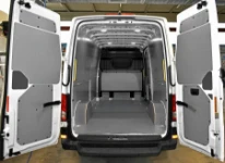 Floor and bulkhead liners in marble-look plywood and steel bodywork liners in a TGE