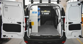 Left-side shelving with pegboard and bins in the Dacia Dokker