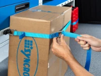 Material secured to the racking by a strap