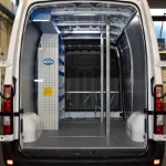 Milled cargo bars installed vertically in a van