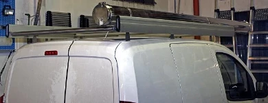 A Fiat Fiorino with a roof rack and pipe carrier