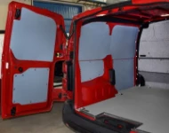 A plywood floor liner and plastic bodywork liners on the left of the Vivaro