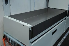 A van racking system with a stainless-steel tray for liquids