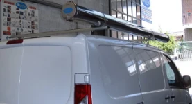 Roof bars with a stainless-steel pipe carrier on a Jumpy