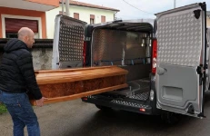 Sliding deck to transport funeral caskets.