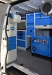 The racking and compressor-generator combo seen through the Sprinter’s side door